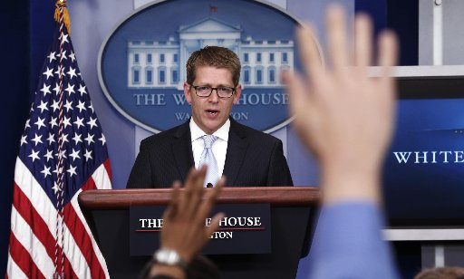 Hands are raised as White House Press Secretary Jay Carney speaks to reporters in the briefing room of the White House in Washington May 14, 2013. The White House, under pressure over reports that the Department of Justice tracked Associated Press...