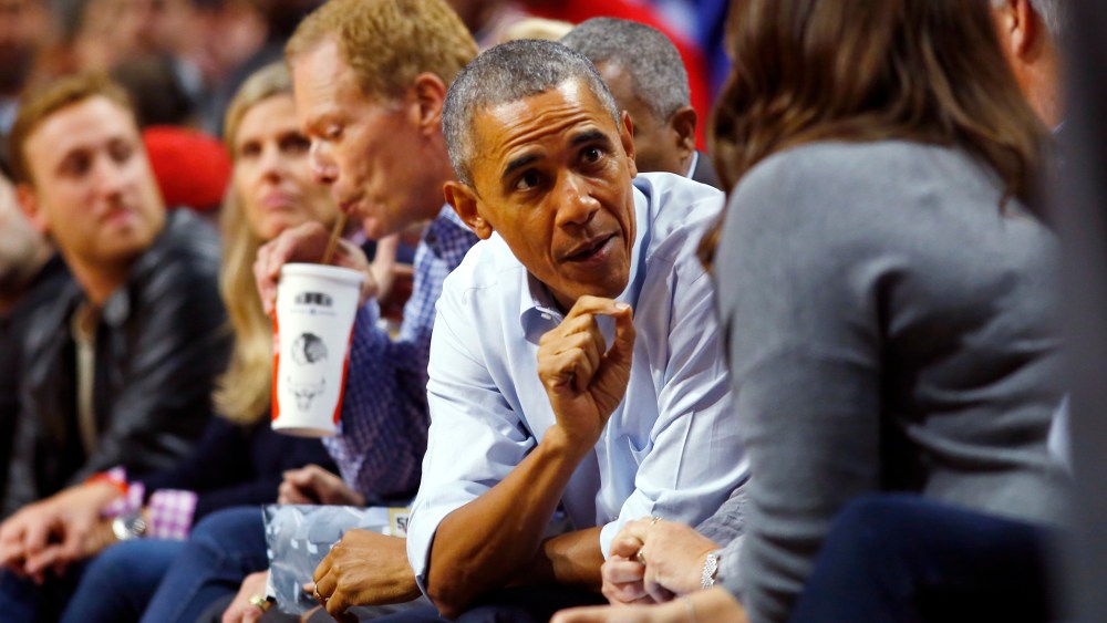 President Barack Obama talks with fans during an NBA basketball game between the Cleveland Cavaliers and the Chicago Bulls in Chicago on Oct. 27, 2015. (Photo by Jeff Haynes/AP)