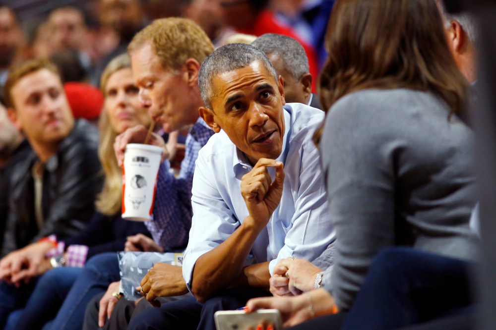 President Barack Obama talks with fans during an NBA basketball game between the Cleveland Cavaliers and the Chicago Bulls in Chicago on Oct. 27, 2015. (Photo by Jeff Haynes/AP)