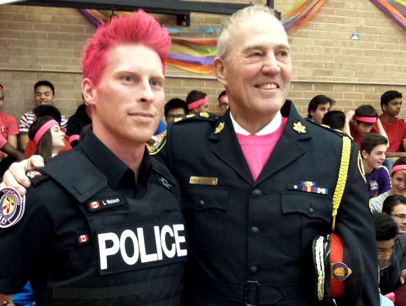 Toronto Police Constable Luke Watson, who dyed his hair pink to raise awareness around LGBT bullying, and his chief at a Day of Pink event at the Forest Hill Collegiate Institute, April 8, 2015. (Photo courtesy of Luke Watson via Twitter)