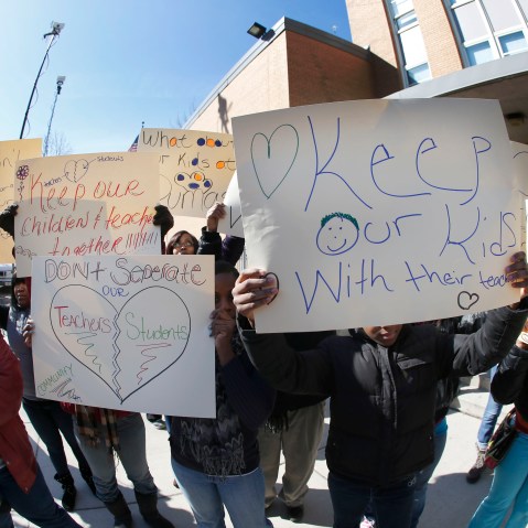 Parents of students at the Dumas Technology Academy Elementary School protest outside the school, the proposed closing of the Southside facility Friday, March 22, 2013, in Chicago. Chicago Public Schools officials ended months of speculation when they...
