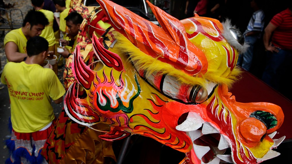 Dragon dancers take a break after performing in front of Chinese business establishments on the eve of Chinese New Year celebration Saturday Feb. 9, 2013 at Manila's Chinatown district of Binondo in Manila, Philippines. This year marks the Year of the...