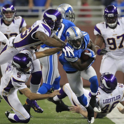 Minnesota Vikings outside linebacker Marvin Mitchell (55) and punter Chris Kluwe (5) take down Detroit Lions' Stefan Logan (11) as he returns a punt during the third quarter of an NFL football game against the Minnesota Vikings at Ford Field in Detroit...