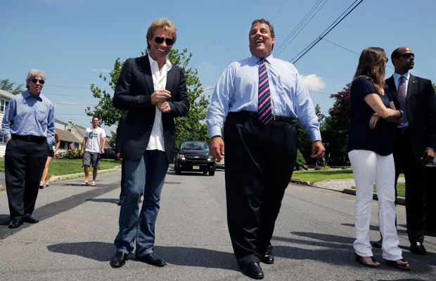 Singer Jon Bon Jovi walks in his hometown of Sayreville, N.J., with New Jersey Gov. Chris Christie on July 8, 2013. (Photo by Mel Evans, Pool/AP)