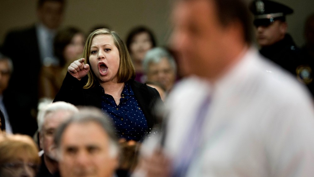 An audience member shouts at New Jersey Gov. Chris Christie during a town hall meeting, on March 13, 2014, in Mount Laurel, N.J.