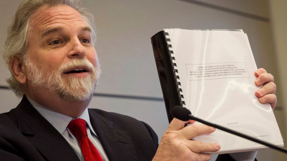 Attorney Randy Mastro holds up a copy of his report during a news conference, Thursday, March 27, 2014, in New York.