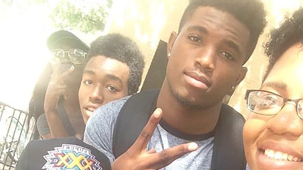 Christian Taylor, pictured with a gray shirt and black backpack, in a photograph taken by his friend and classmate, Liz. (Photo courtesy of @_lawjohnson)