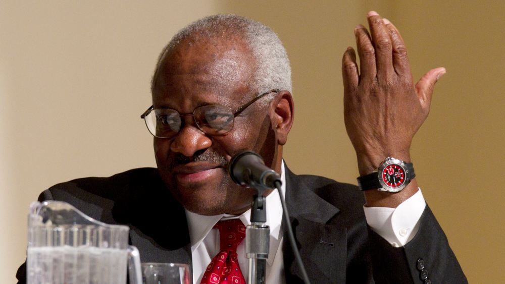 Supreme Court Justice Clarence Thomas gestures while taking part in a panel discussion at College of the Holy Cross in Worcester, Mass., Thursday, Jan. 26, 2012. (Photo by Michael Dwyer/AP)