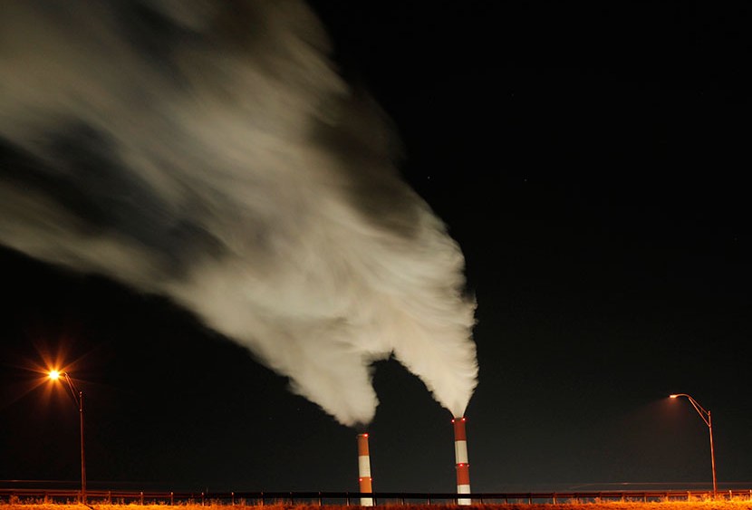 In this Jan. 19, 2012, file photo time exposure image smoke rises from the stacks of the La Cygne Generating Station coal-fired power plant in La Cygne, Kan. (Photo by Charlie Riedel/AP)