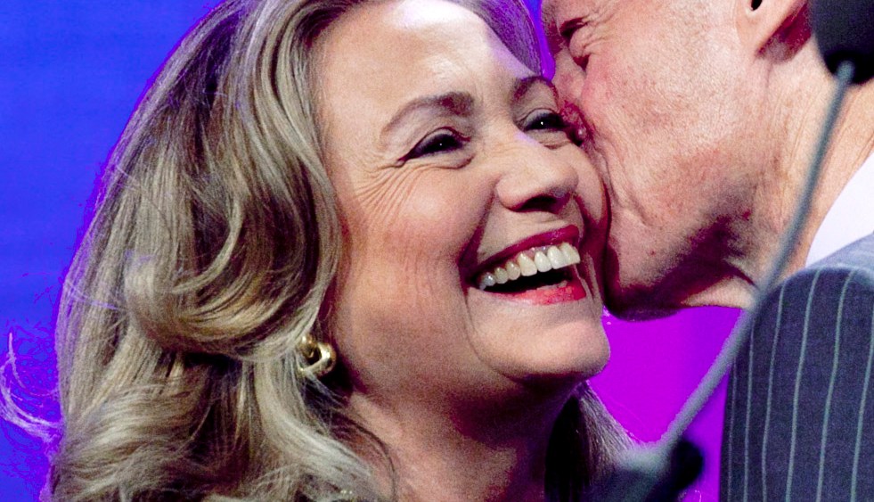 CROPPED VERSION OF NYML101 -- United States Secretary of State Hillary Rodham Clinton is kissed by her husband, former U.S. President Bill Clinton, as he welcomes her to  the podium at the Clinton Global Initiative, Monday, Sept. 24, 2012 in New York. ...