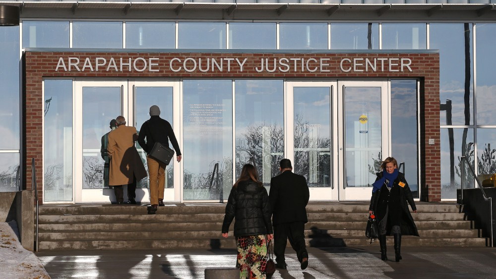 People enter the Arapahoe County Justice Center in Centennial, Colo., on Jan. 20, 2015. (Photo by Brennan Linsley/AP)