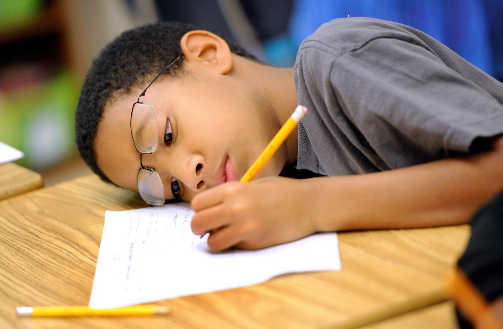 Jelani Guzman, a fifth-grader at Silver Lake Elementary School in Middletown, Del., works on an English language arts lesson at school Tuesday, Oct. 1, 2013.