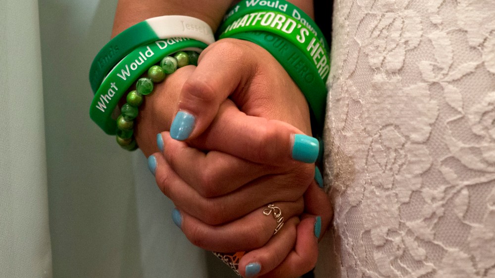 Jillian Soto, left, and Carlee Soto, sisters of Newtown, Conn. shooting victim Victoria Soto, hold hands during a news conference on Capitol Hill in Washington, Thursday, June 13, 2013,  (AP Photo/Jacquelyn Martin)