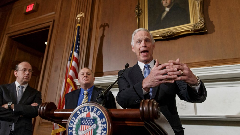Sen. Ron Johnson, R-Wis., joined by attorneys Paul D. Clement, far left, and Rick Esenberg, second from left, announces that he has filed a lawsuit to block the federal government from helping to pay for health care coverage for members of Congress and th