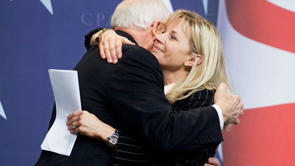 Former Vice President Dick Cheney hugs his daughter, Liz Cheney, after she surprised the Conservative Political Action Conference (CPAC) by bringing him as her guest. (AP Photo/Cliff Owen)