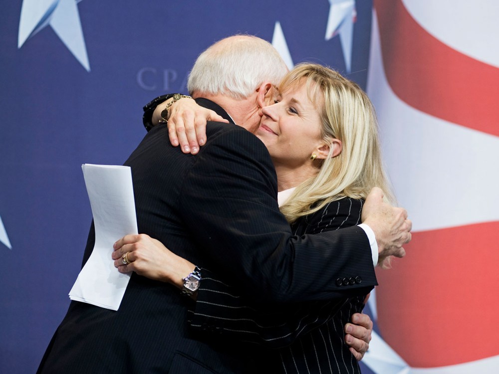 Former Vice President Dick Cheney hugs his daughter, Liz Cheney, after she surprised the Conservative Political Action Conference (CPAC) by bringing him as her guest. (AP Photo/Cliff Owen)