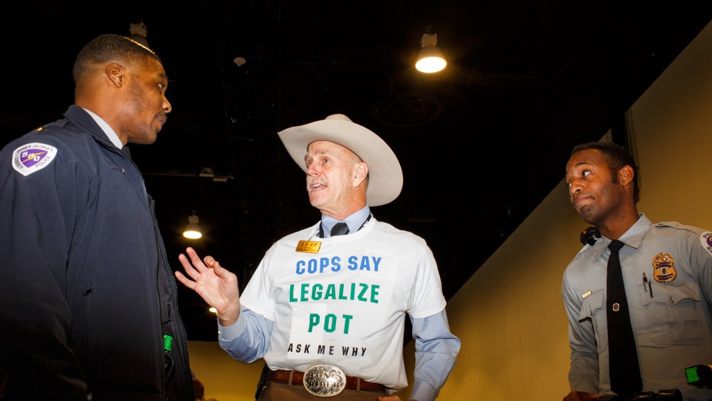 Howard "Cowboy" Wooldridge, co-founder of Law Enforcement Against Prohibition, speaks to two Prince Georges County police officers at CPAC in National Harbor, Md., on Feb. 27, 2015. (Photo by Melissa Golden/Redux for MSNBC)