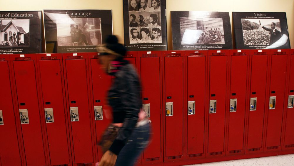 A student at Walter H. Dyett High School walks through the hallway in Chicago, Illinois, in this photo taken on October 5, 2012. The bipartisan education reform movement sweeping the nation calls for rating schools by their students' test scores and...