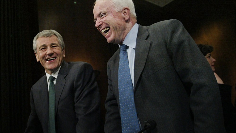 Chuck Hagel, center, R-Neb, and John McCain, right, R-Ariz, share a laugh on the Capitol Hill, Thursday, Feb. 12, 2004 in Washington.   (Photo by Manuel Balce Ceneta/AP)