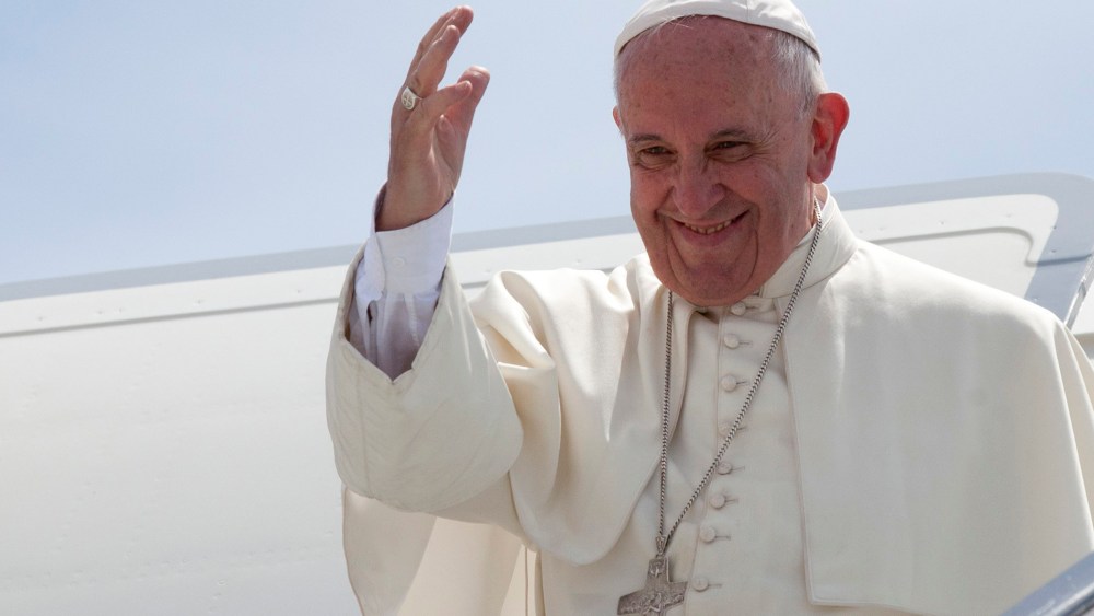 Pope Francis waves from the top of the stairs of his plane at the airport in Santiago, Cuba, Sept. 22, 2015. (Photo by Ismael Francisco/AP)