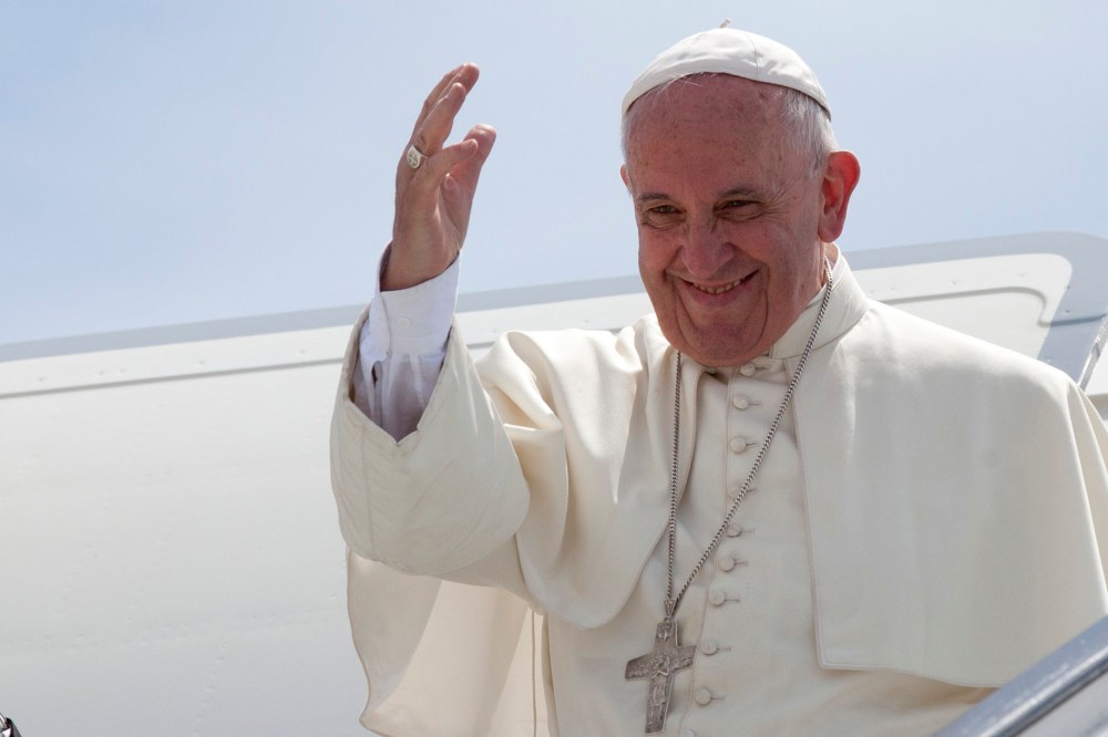 Pope Francis waves from the top of the stairs of his plane at the airport in Santiago, Cuba, Sept. 22, 2015. (Photo by Ismael Francisco/AP)