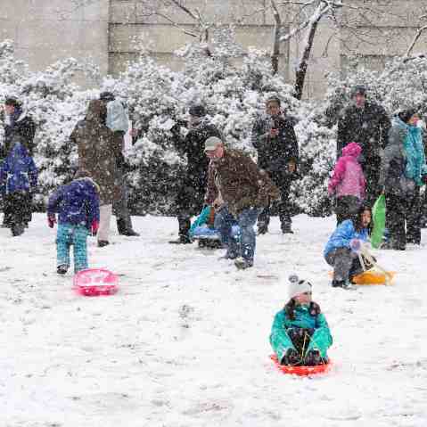 Children sled on the west lawn of the U.S. Capitol during a snow storm in Washington