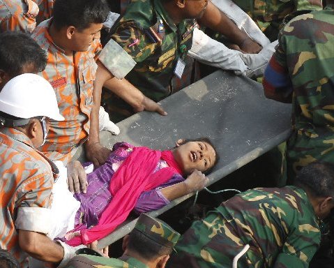 Bangladeshi rescuers retrieve garment worker Reshma from the rubble of a collapsed building in Savar on May 10, 2013, seventeen days after the eight-story building collapsed. AFP PHOTO/AFP/Getty Images