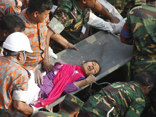 Bangladeshi rescuers retrieve garment worker Reshma from the rubble of a collapsed building in Savar on May 10, 2013, seventeen days after the eight-story building collapsed. AFP PHOTO/AFP/Getty Images