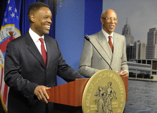 Detroit emergency financial manager Kevyn Orr, left, appears before the media later in the morning Moday, March 25, 2013, in Detroit following Mayor Dave Bing's, right, announcement of a public safety collaboration with local business leaders. (AP...