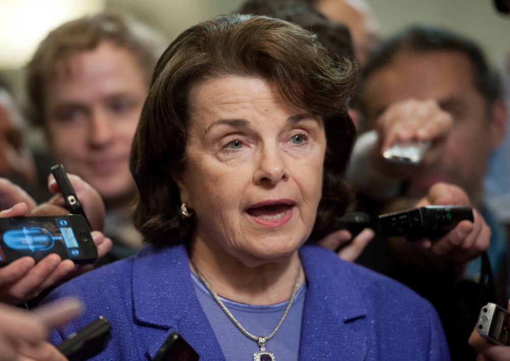 Senate Intelligence Committee Chair Sen. Dianne Feinstein, D-Calif., is surrounded by reporters on Capitol Hill in Washington, Friday, Nov. 16, 2012, following a closed-door hearing of the committee where former CIA Director David Petraeus testified. ...