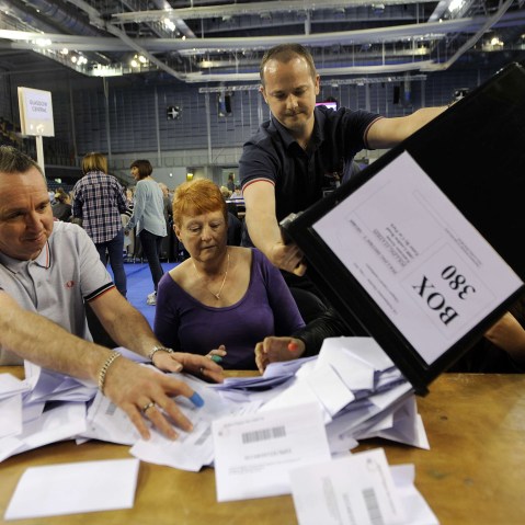 Counting staff sort through ballot papers at the counting centre at the Emirates Arena in Glasgow on May 7, 2015 after the polls closed in the British general election. (Photo by Andy Buchanan/AFP/Getty)