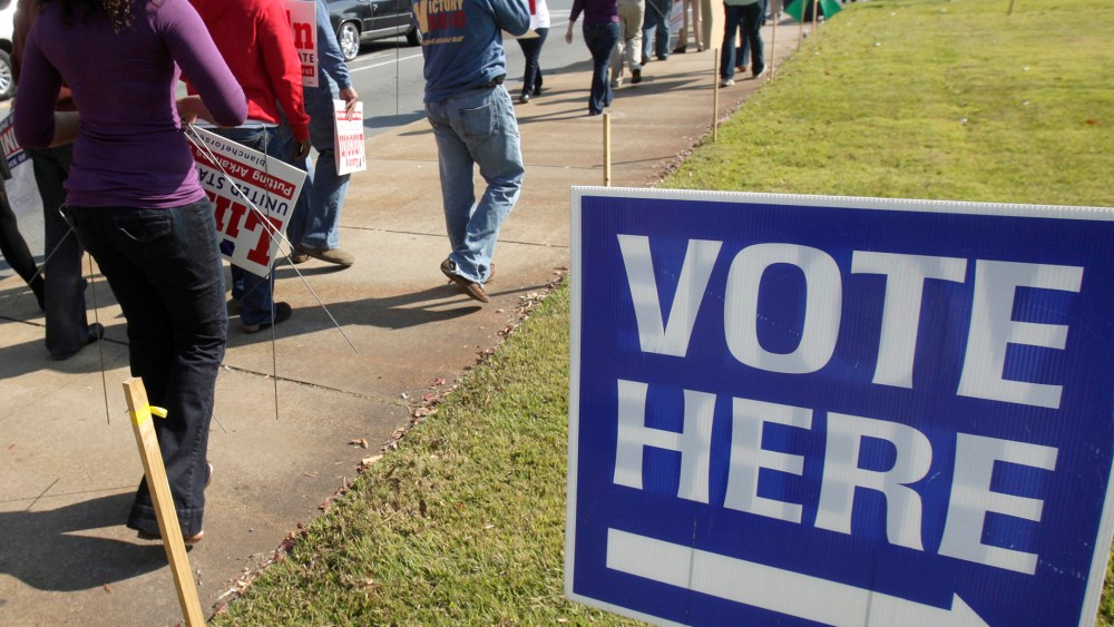 Campaign workers and volunteers walks past an early voting polling place in Little Rock, Ark., Monday, Oct. 18, 2010.