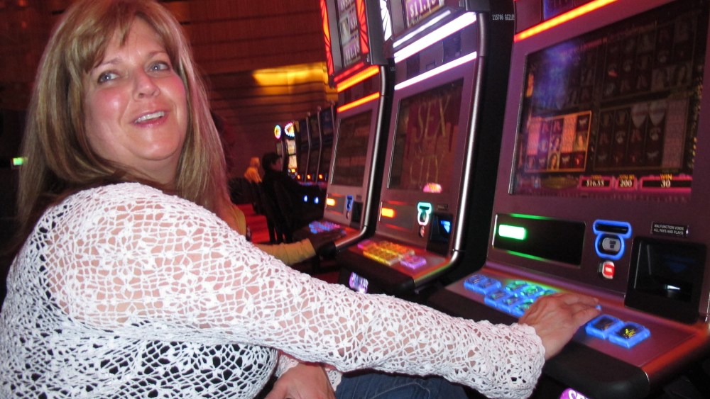 FILE - In this May 21, 2012 file photo, Donna Kiddie of Point Pleasant Beach N.J. plays a "Sex And The City" slot machine at Revel in Atlantic City N.J. Revel, which is in federal bankruptcy court, posted a $110 million operating loss in the nine...