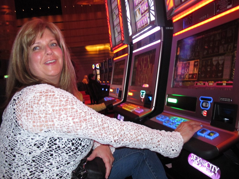 FILE - In this May 21, 2012 file photo, Donna Kiddie of Point Pleasant Beach N.J. plays a "Sex And The City" slot machine at Revel in Atlantic City N.J. Revel, which is in federal bankruptcy court, posted a $110 million operating loss in the nine...