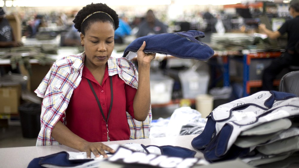 Laurette Eugene makes the final assembly of body armor at the Point Blank Body Armor factory in Pompano Beach, Fla. on Sept. 19, 2014.