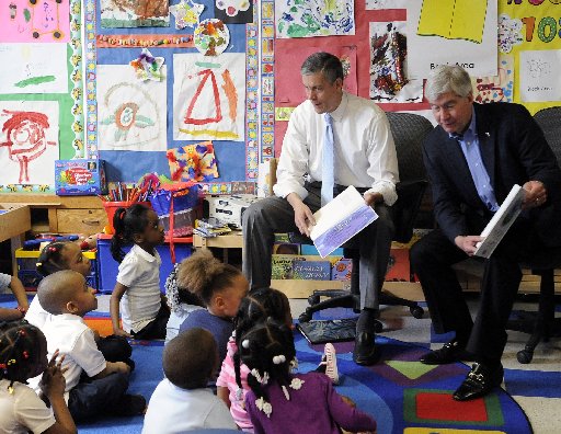 U.S. Education Secretary Arne Duncan and Michigan Gov. Rick Snyder read "The Rainbow Fish" book to a pre-kindergarten class at Thirkell Elementary School in Detroit on Monday, May 6, 2013.  (AP Photo/Detroit News, David Coates)
