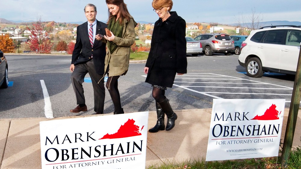 Sen. Mark Obenshain, Republican candidate for attorney general, heads to the polls with his family, Tuesday, Nov. 5, 2013 in Harrisonburg, Va.