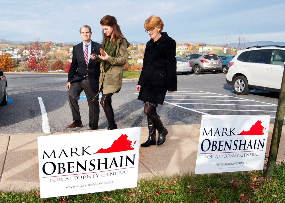 Sen. Mark Obenshain, Republican candidate for attorney general, heads to the polls with his family, Tuesday, Nov. 5, 2013 in Harrisonburg, Va.