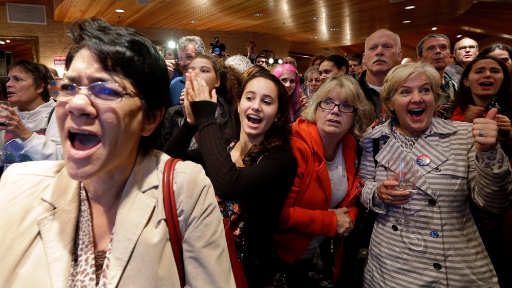 Supporters cheer as results come in at an election night party for Initiative 594, a measure seeking universal background checks on gun sales and transfers, on Nov. 4, 2014, in Seattle.