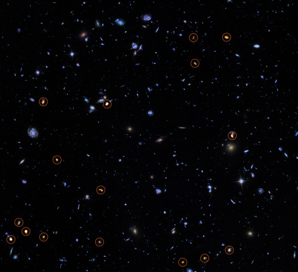 This image combines a background picture taken by the NASA/ESA Hubble Space Telescope (blue/green) with a new very deep ALMA view of this field (orange, marked with circles).