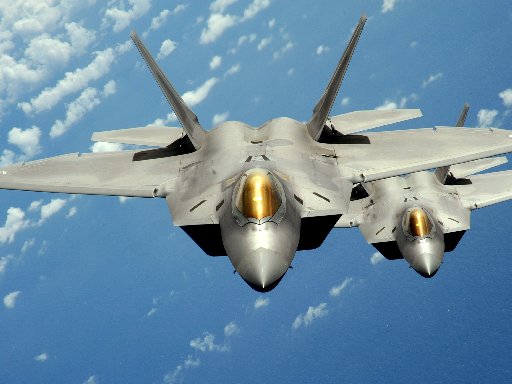 Two U.S. Air Force F-22 Raptor stealth jet fighters fly near Andersen Air Force Base in Guam in this handout photo dated August 4, 2010.   REUTERS/U.S. Air Force/Master Sgt. Kevin J. Gruenwald/Handout