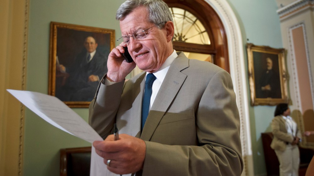 Sen. Max Baucus, D-Mont, steps off the Senate floor just after the bipartisan passage of the Farm Bill, at the Capitol in Washington, Thursday, June 21, 2012.