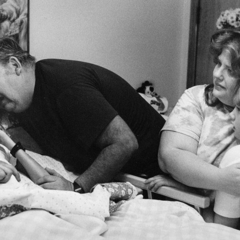 David Kirby, an HIV/AIDS activist, near death, surrounded by his family in Ohio, 1990.
