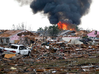 A scene of fire and destruction in Moore, Oklahoma after a tornado ripped through the area on May 20, 2013. (Photo by Sue Ogrocki/AP)