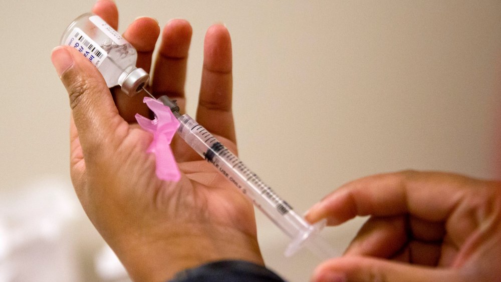 A nurse prepares a flu shot at the Salvation Army in Atlanta, Wednesday, Feb. 7, 2018.