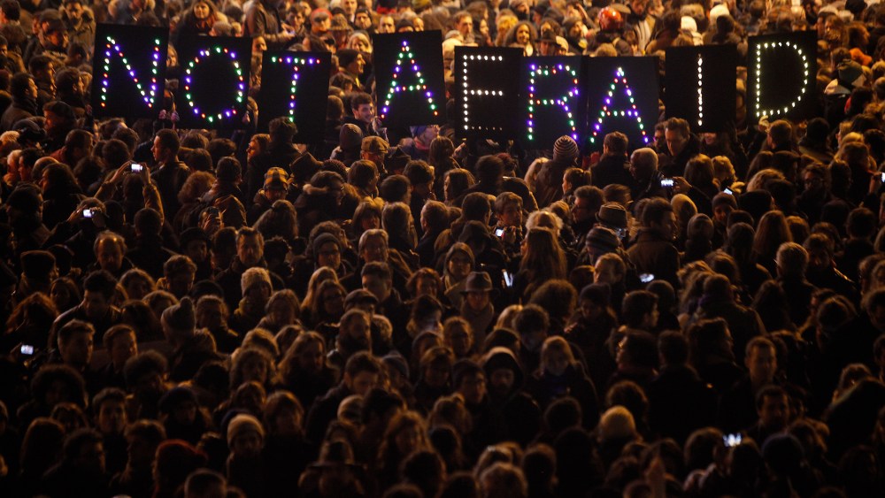 People gather in solidarity of the victims of a terror attack against a satirical newspaper, in Paris, on Jan. 7, 2015.