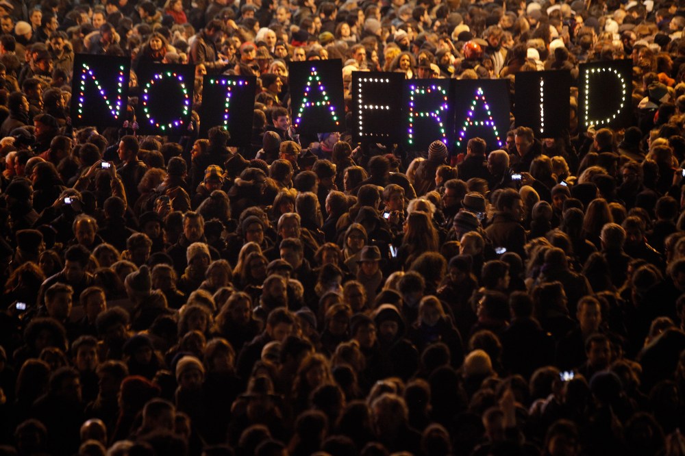 People gather in solidarity of the victims of a terror attack against a satirical newspaper, in Paris, on Jan. 7, 2015.