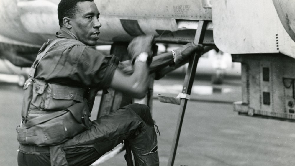 Lieutenant Colonel Frank E. Petersen, Jr. climbs into his phantom jet for a combat mission in Vietnam in 1968. (Photo by SSgt Stacy/Marine Corps)
