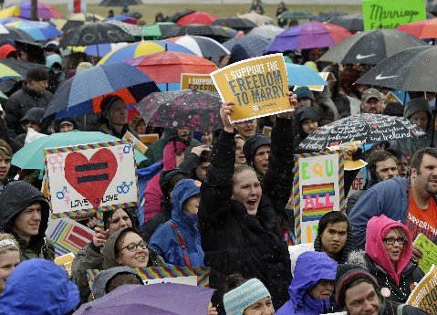 Hundreds turned out to brave rain, ice pellets and snow during a rally in support of a bill to legalize gay marriage at the Minnesota State Capitol, Thursday, April 18, 2013 in St. Paul, Minn.  Gov. Mark Dayton told the crowd he hoped legislators pass...