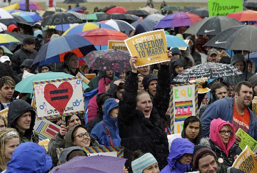 Hundreds turned out to brave rain, ice pellets and snow during a rally in support of a bill to legalize gay marriage at the Minnesota State Capitol, Thursday, April 18, 2013 in St. Paul, Minn. Gov. Mark Dayton told the crowd he hoped legislators pass...